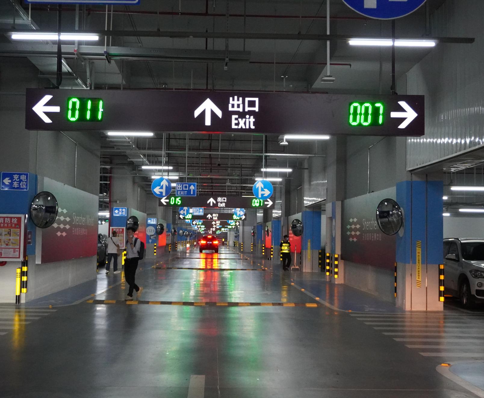 Indoor parking guidance display showing available spaces and directions in an exhibition center garage