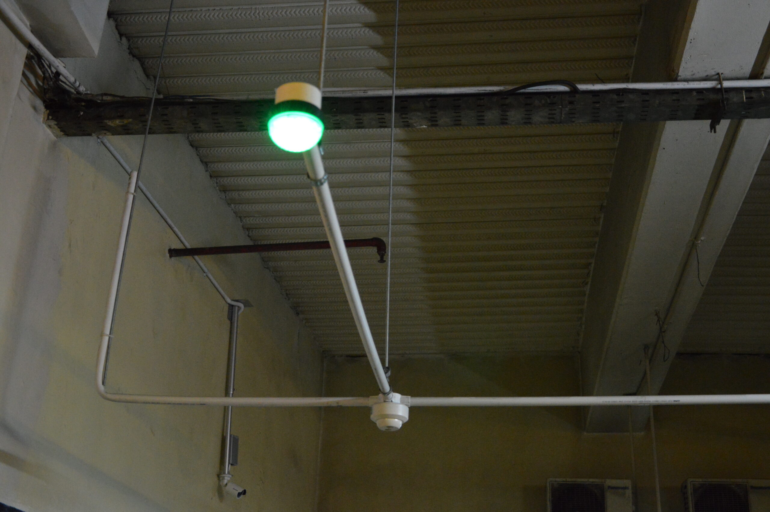 A suspended detector and green parking-space indicator at Pondok Indah.