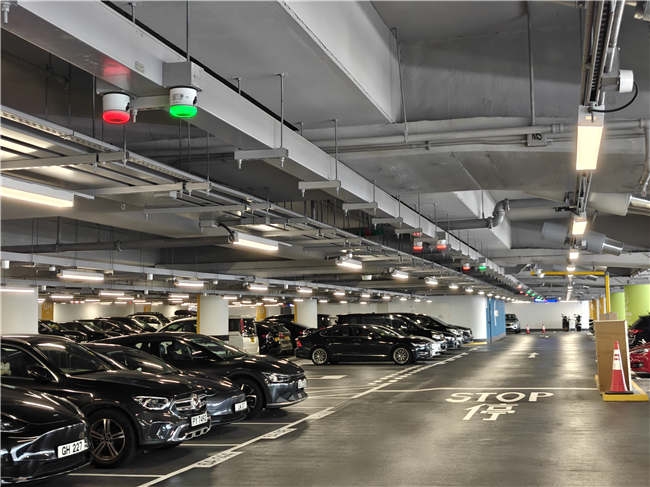 Regular-car parking and overhead guidance equipment at Hong Kong Airport Terminal 2.