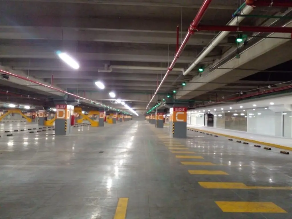 Overhead parking indicators and lettered zones at Riocentro Shopping Quito.